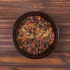 Spice mix - paprika, barberry, saffron, cumin, marjoram in a bowl on a wooden background