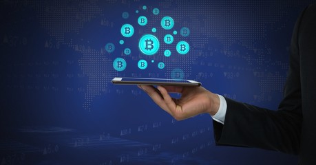 Bitcoin icons and hand holding tablet