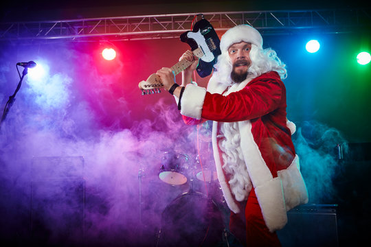 Santa Claus plays rock.