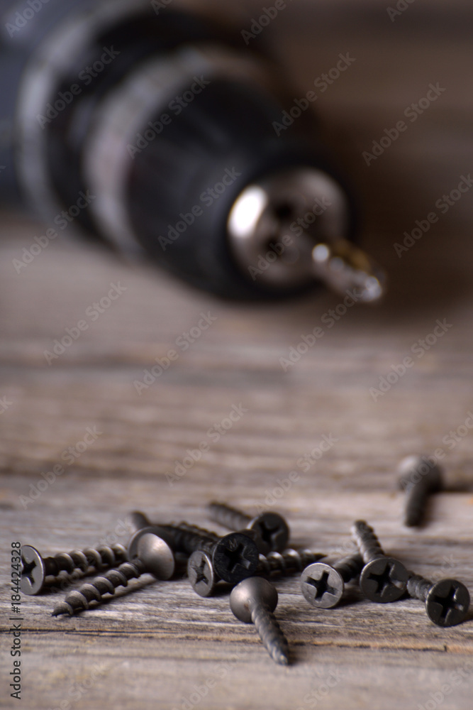 Wall mural close up electric drill on wooden table background and copy space. hammer drill or screwdriver, elec