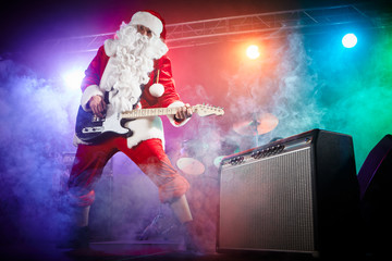 Santa Claus plays rock.