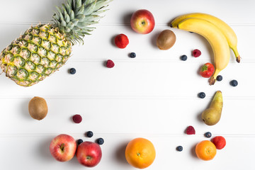 white table overhead view fresh ripe spring summer fruit variety pineapple banana apple berries mango