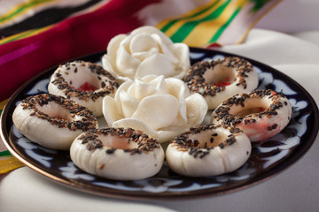 Eastern desserts.Halva with sesame seeds on a plate.Uzbek sweets.