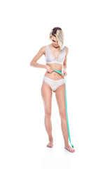 girl in lingerie measuring her perfect slim body, isolated on white