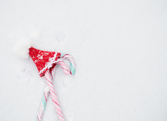 Christmas candies and mini Santa Claus hat. Flat lay