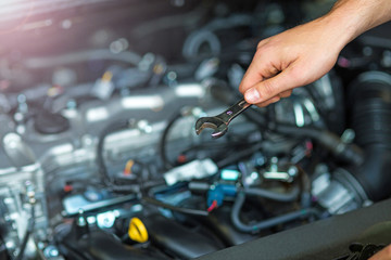 Hands of mechanic working in auto repair shop

