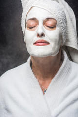 woman is white clay on his face mask