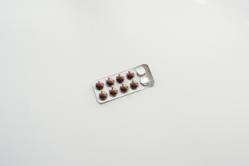 Old bottle of pills on white background