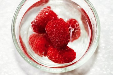 Small glass with raspberry.