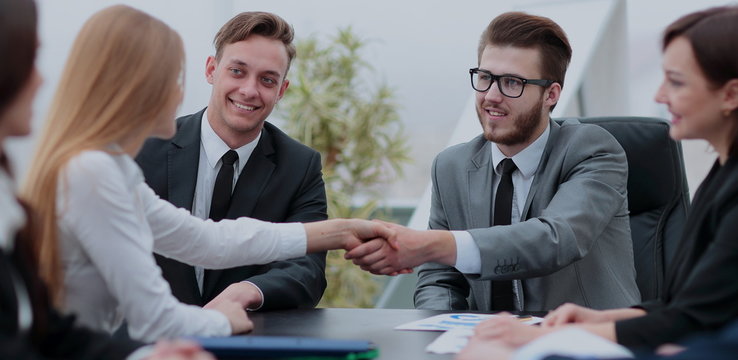 Successful  businesspeople shaking hands in a modern office