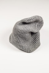 Grey knitted hat on a white background