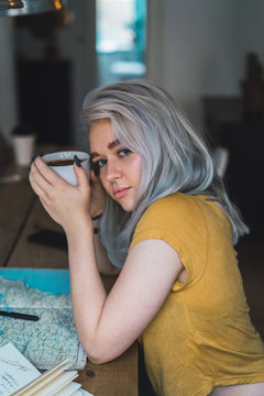 Dreamy woman with cup