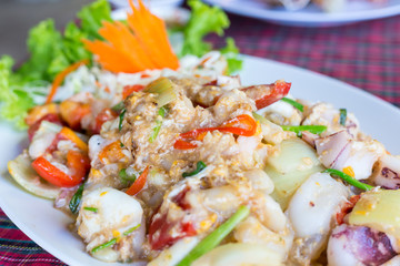 Fish fillets baked with wild champignons and small squids