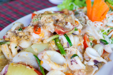 Fish fillets baked with wild champignons and small squids