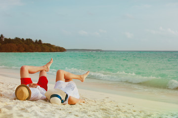 happy couple relax on a tropical beach