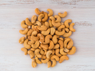Top view of cashews on a wooden background