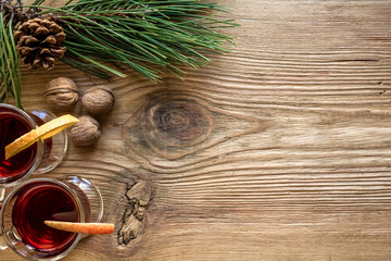 Mulled wine with spices on wooden background
