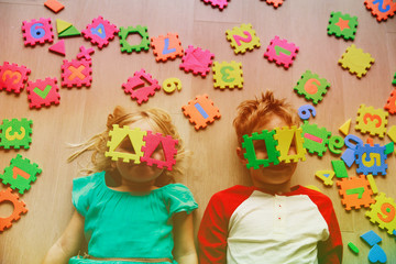 happy little girl and boy learn numbers and shapes