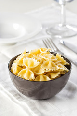 Farfalle pasta in a bowl with copy space