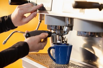 Cropped image of woman making coffee