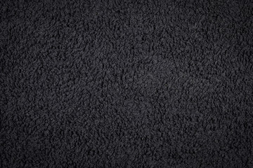 Black towel fabric closeup, texture pattern background