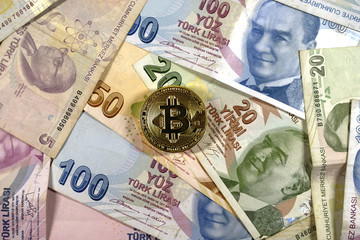 Turkish Lira banknotes and bitcoin coin