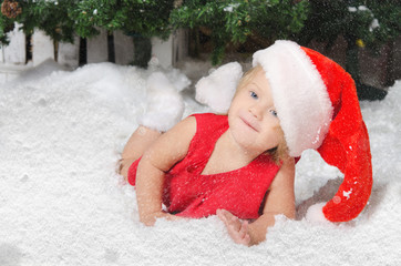 smiling girl in santa costume on snow