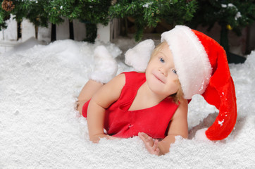 smiling little girl in santa costume on snow