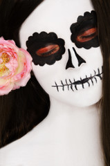 woman with black and white face art on her face