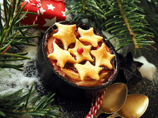 Christmas background with homemade apple pie, fir tree and snowflakes