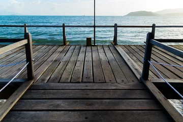 Foto op Canvas Perspective view wooden pier on the blue sea beach, summer time. © Emoji Smileys People