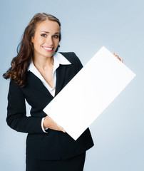 Businesswoman showing signboard, over blue