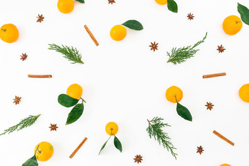 Frame made of citrus, cinnamon and fir branches on white background. Flat lay. Top view