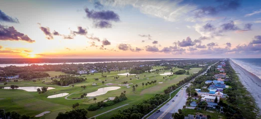 Fototapeten An aerial view looking over a golf course at sunset © crazymonkstudio
