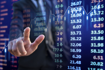 Businessman touch growth stock market graph with stock market chart financial data on electronic board background, double exposure