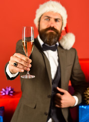 New year eve. Santa in retro suit shows alcoholic drink