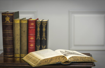 A stack of old books on the coffee table.