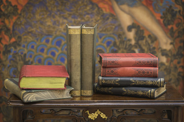 A stack of vintage books on the coffee table.