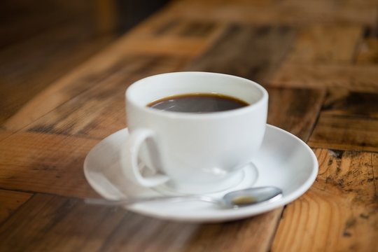 Close up of black coffee on wooden table