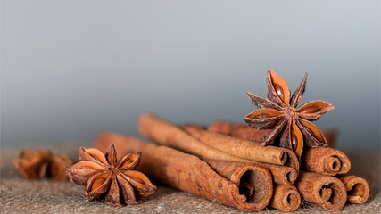 Star anise and Cinnamon as a spices on the brown cloth with gradient gray background