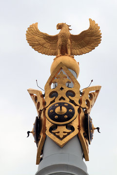 Astana. Kazakhstan. Golden figure of a bird Samruk at the top of the majestic monument "Kazakh Eli". Area Peace and Accord.