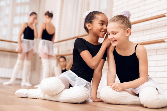 Young ballerinas rest during a break in the ballet classes.