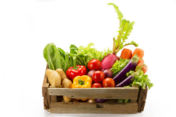 Assortment of fresh vegetables in basket isolated white background, organic and biological concept