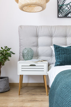 Simple bedroom with white nightstand