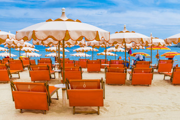 Beach chairs and umbrella on the Fetovaia beach in Elba island, Tuscany, Italy.