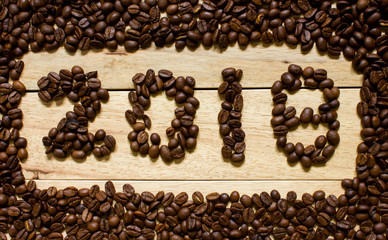 2018 coffee bean text on wood background, new year concept