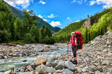 Happy hiker at mountain river