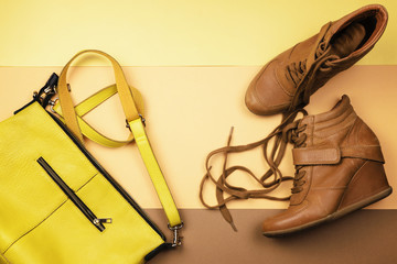 Leather brown boots and other accessories on a brown background. Flat lay. The view from the top.