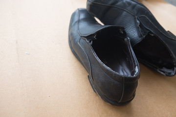Old pair of used black leather shoes