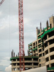 building under construction with crane